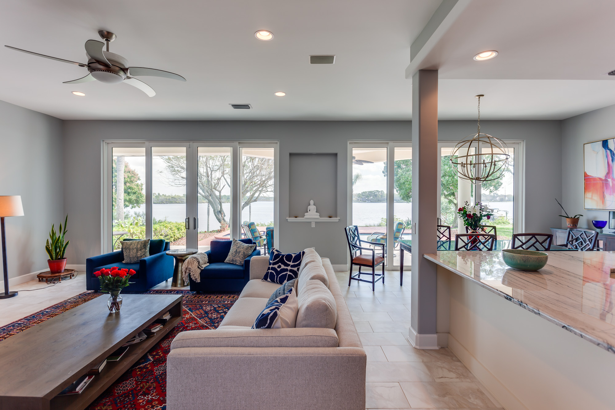 entertaining room with living, dining and kitchen areas with lots of natural light from large sliding doors