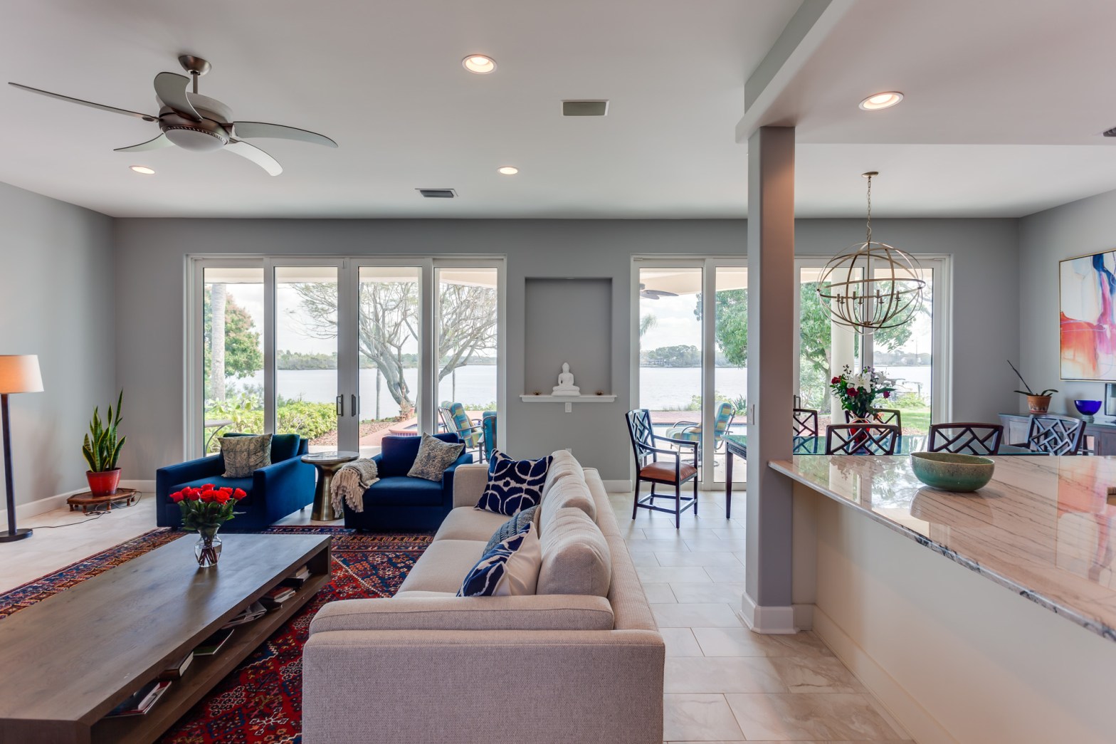 entertaining room with living, dining and kitchen areas with lots of natural light from large sliding doors