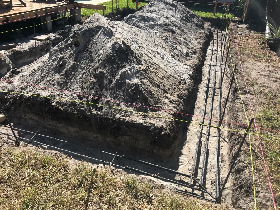 digging out the footing and reusing it as fill inside the future foundation walls