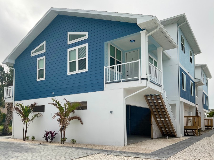 Duplex with living floors raised above parking