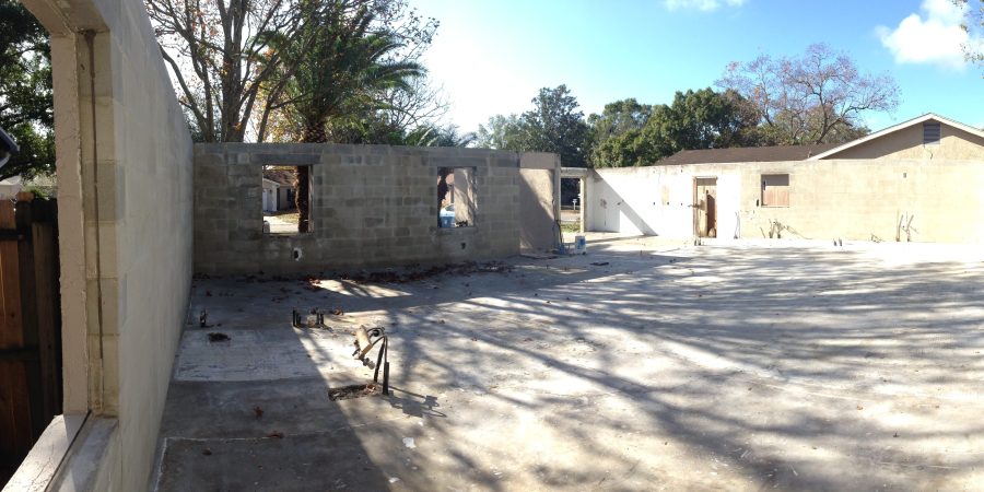 Concrete block house walls and slab after fire destroyed the roof and interior