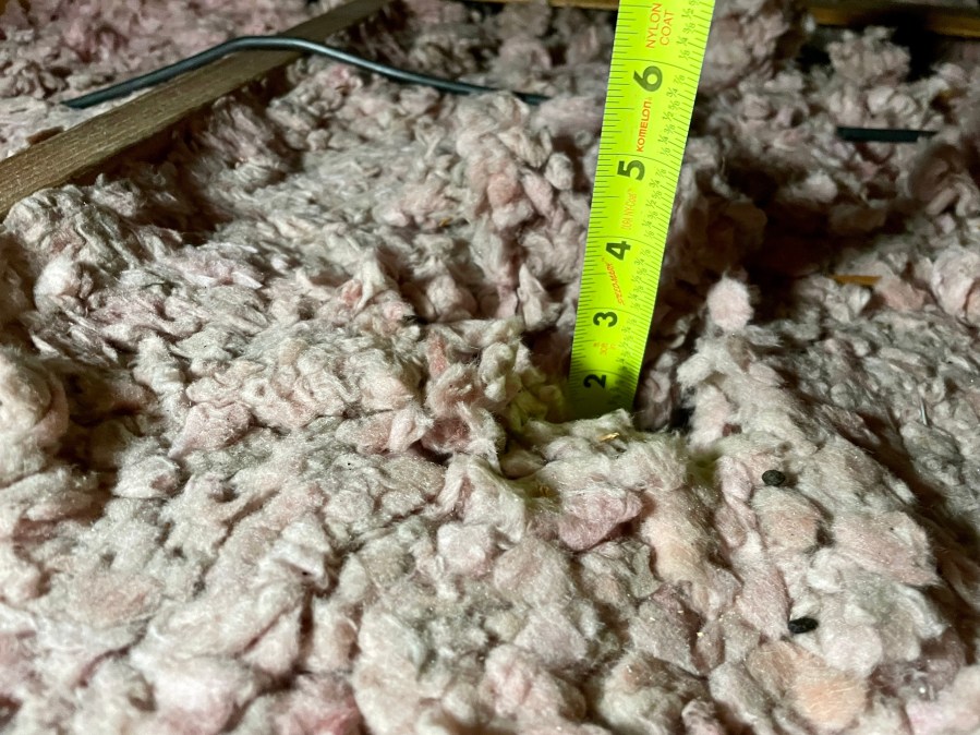 Uneven fiberglass attic insulation depth in Florida home